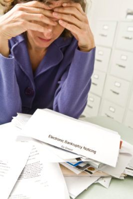 Distraught woman with bankruptcy notice